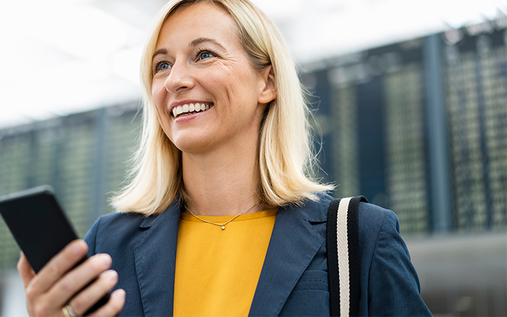 women smiling looking at phone