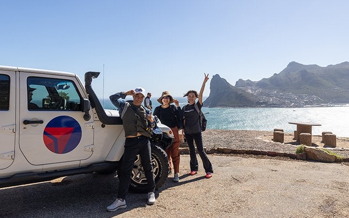 group photo in front of the ocean