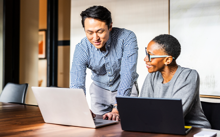 Two people discussing reports