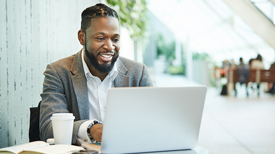 A man on a laptop looking at the FCM platform