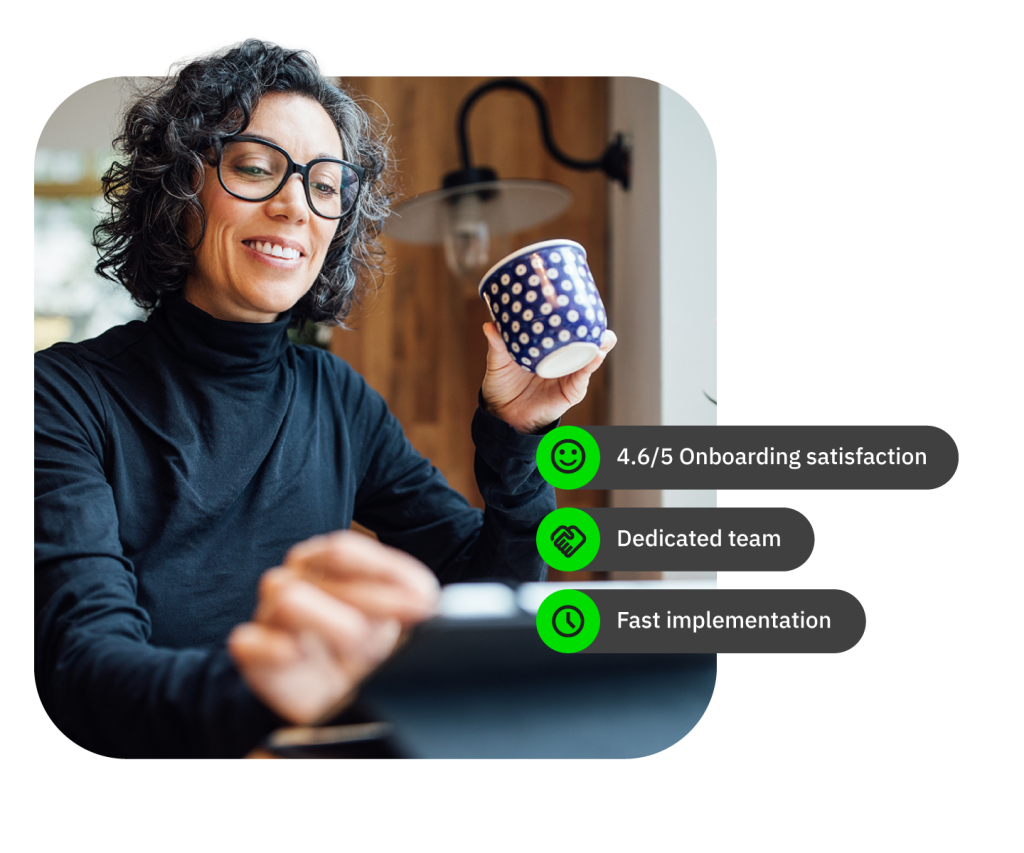 Person holding mug in wood-paneled room with overlay text: satisfaction, team, implementation