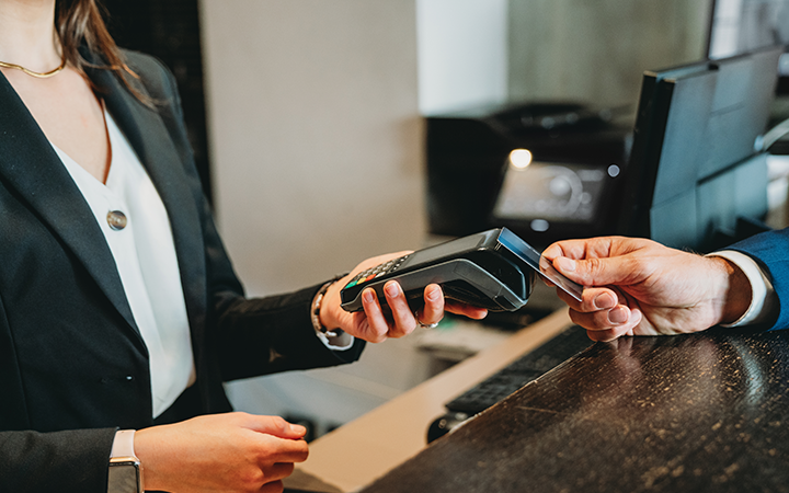 Business traveler making a payment with a card machine