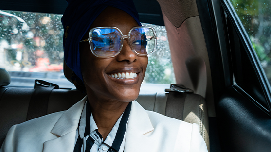 Businesswoman sitting in a car enjoying FCM’s tailored solutions for the fast-moving consumer goods industry