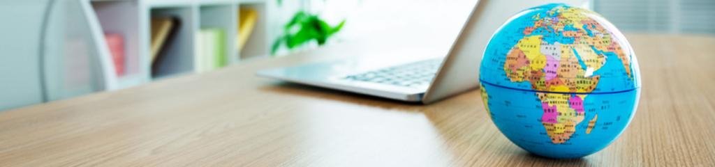 Globe on desk with laptop