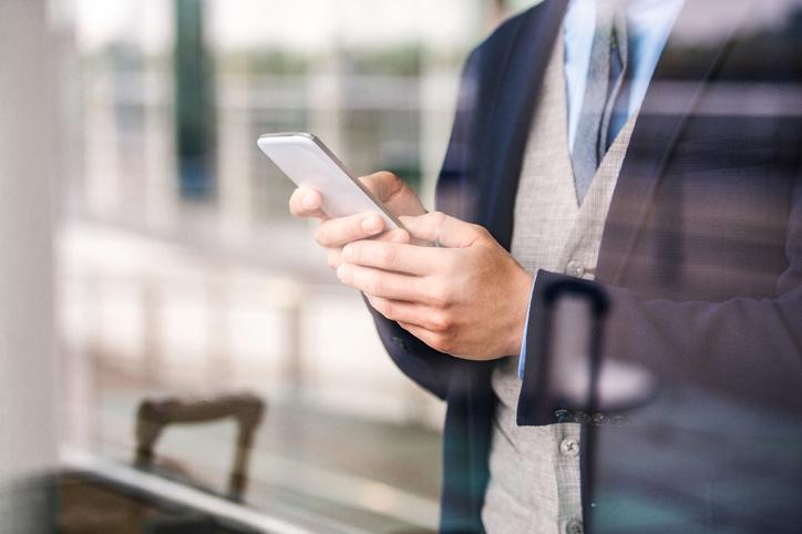 Man in suit using mobile phone