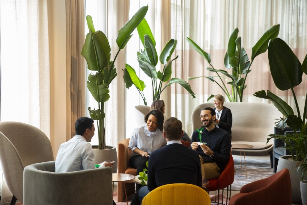miling entrepreneurs discussing while sitting in office.jpg