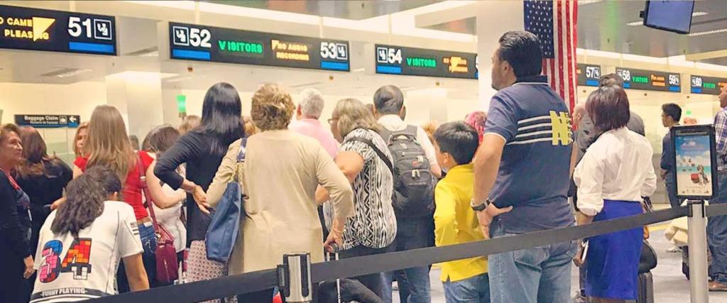 Passengers looking at flight status at airport