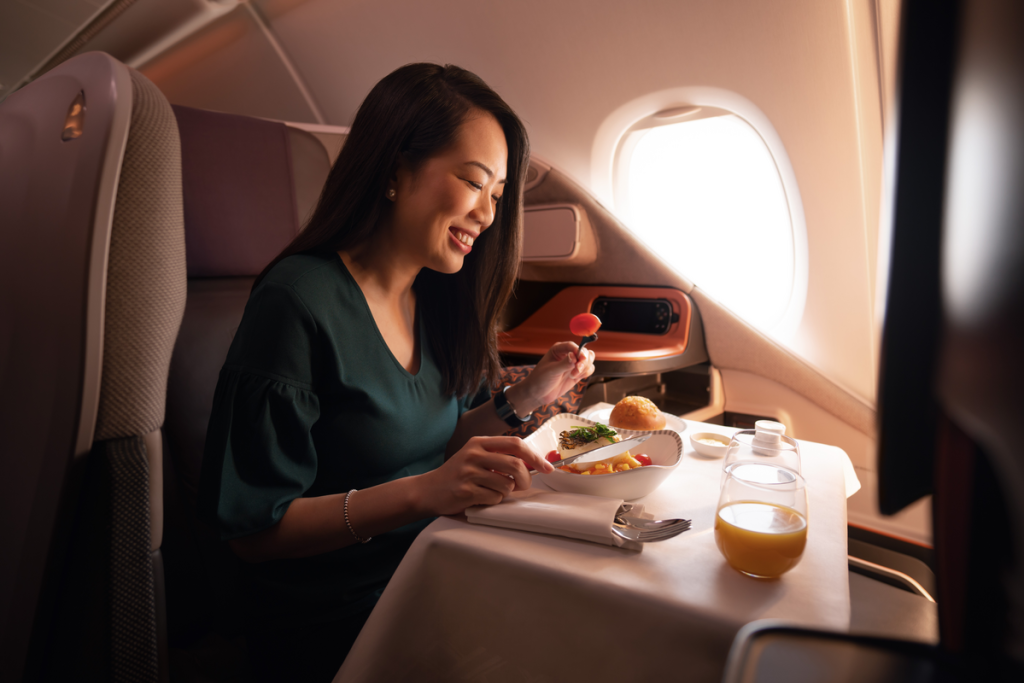 woman-enjoying-meal-business-class