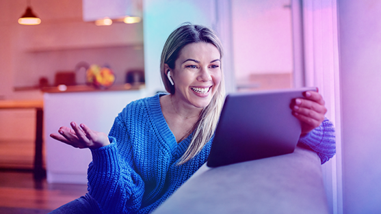 Woman on iPad smiling