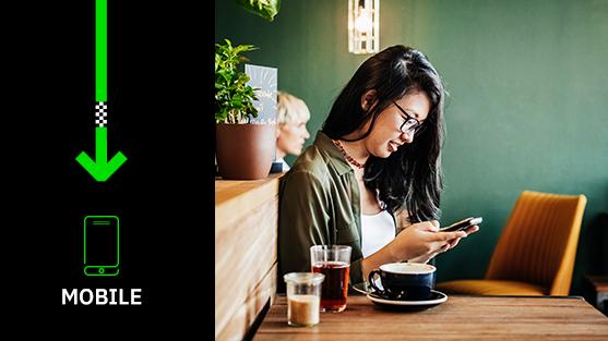 Woman looking at phone in cafe